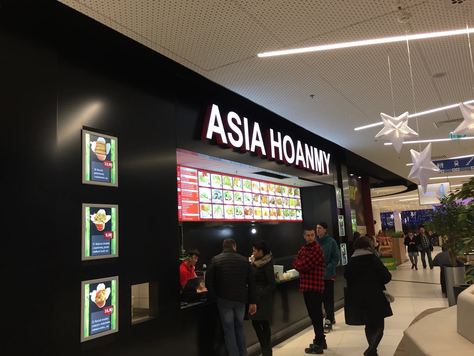 ASIA HOANNY — Advertising lightbox with LED backlight mounted on a fast-food restaurant facade, containing a menu with photos of dishes
