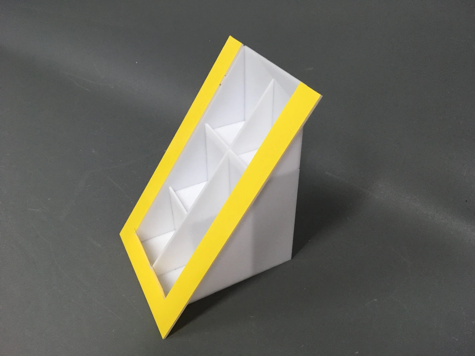 Cosmetics industry — countertop sloped display for cosmetics — white body from frosted PMMA + yellow front frame, 6 compartments