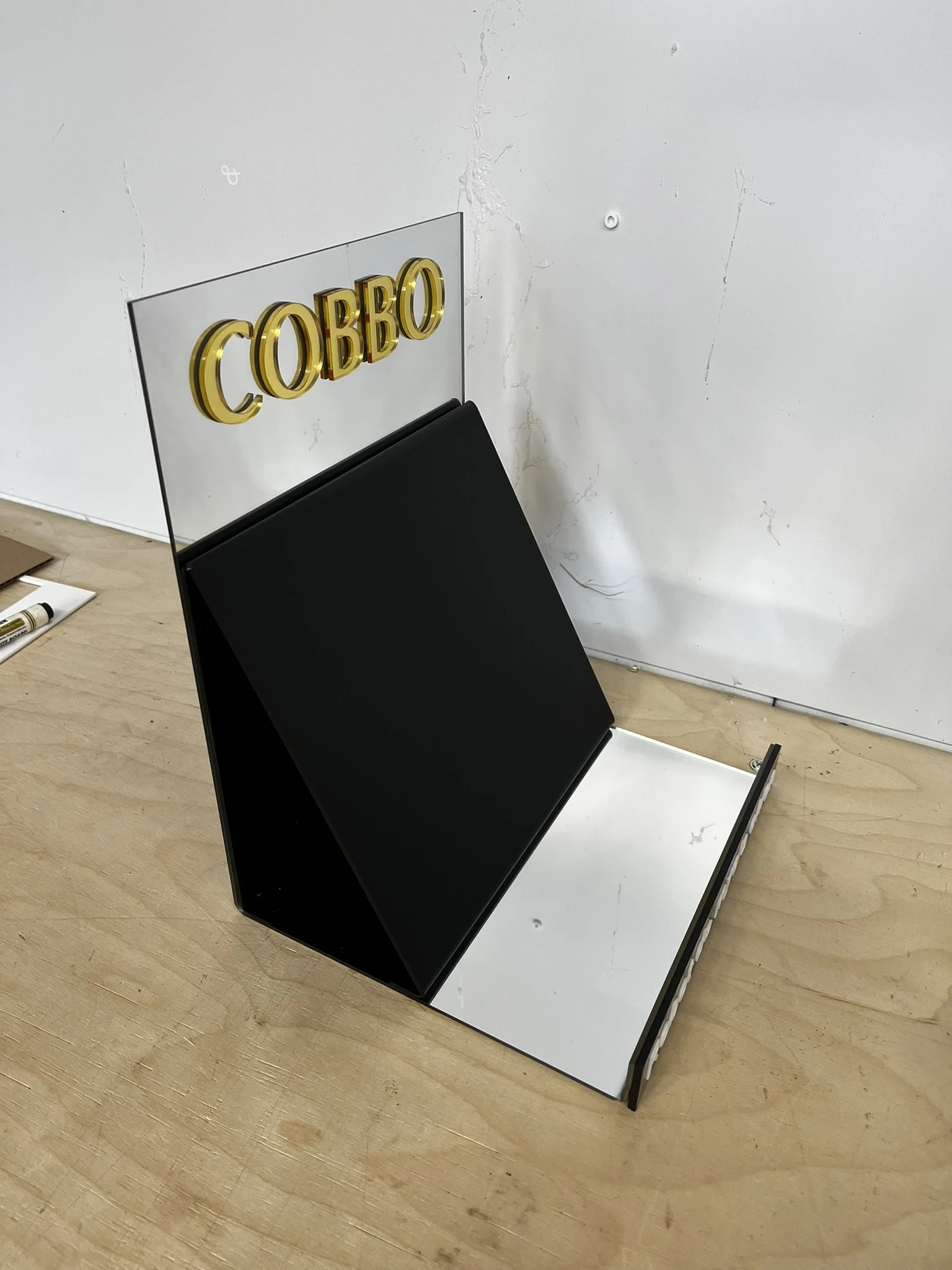 COBBO — POS display from acrylic for pulpicie - black base from white shelf and transparentm panelem upper from gold logo brand