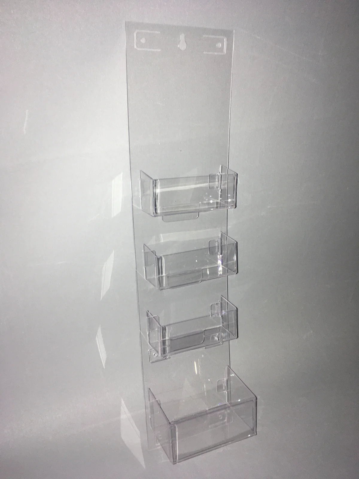 Stand for leaflets from clear acrylic — four pockets from mocowaniem wall-mountedm