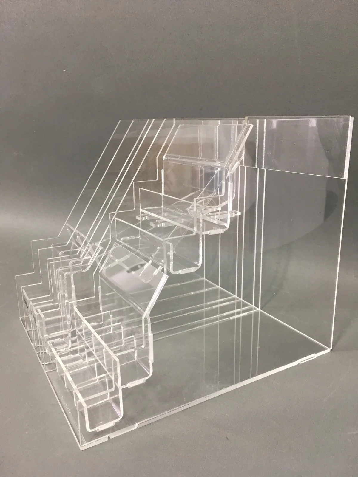 Multi-level stepped display in clear acrylic — six steps