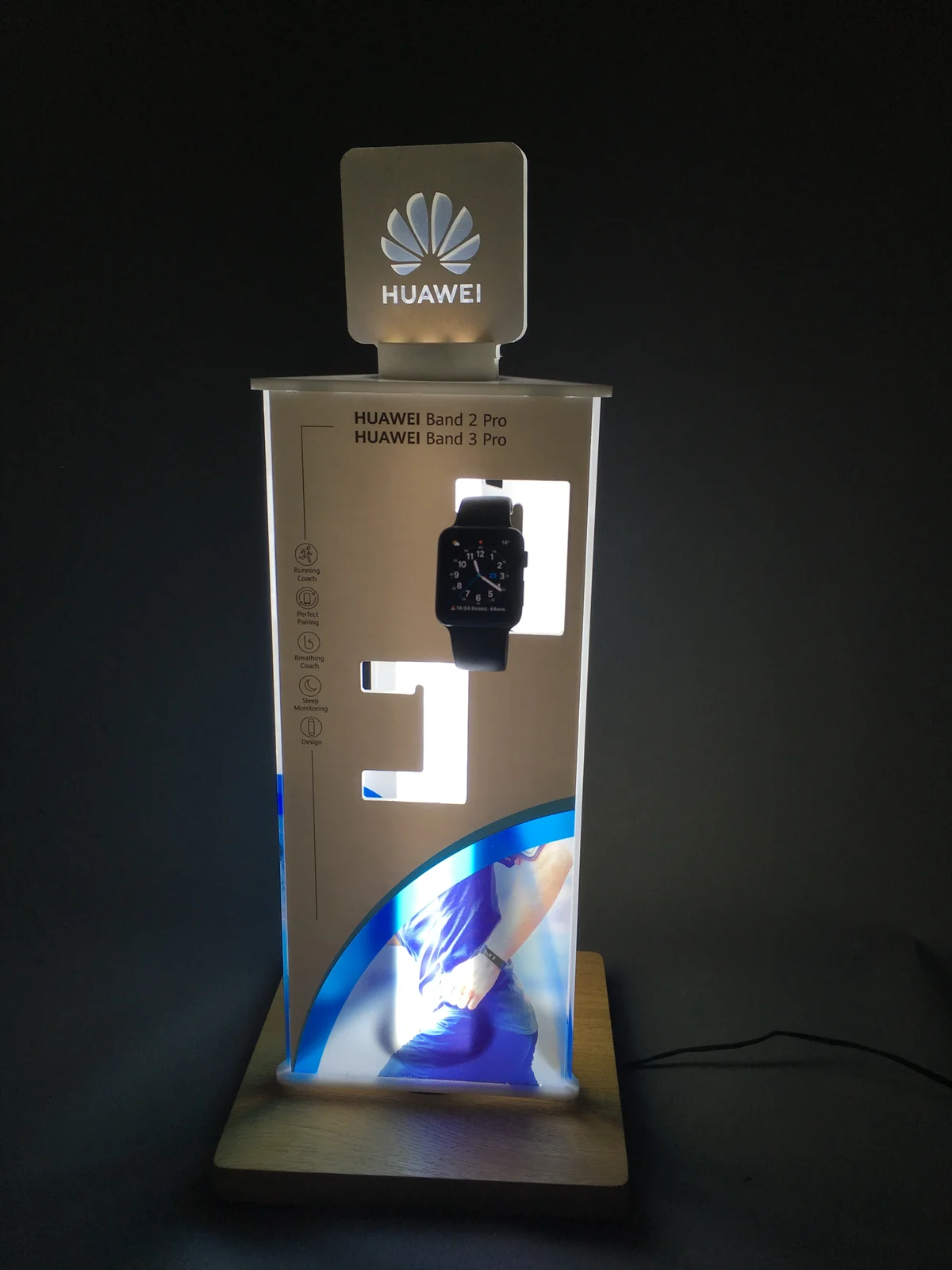 LED presentation post from Dibond and acrylic with wooden base and electronics-brand logo
