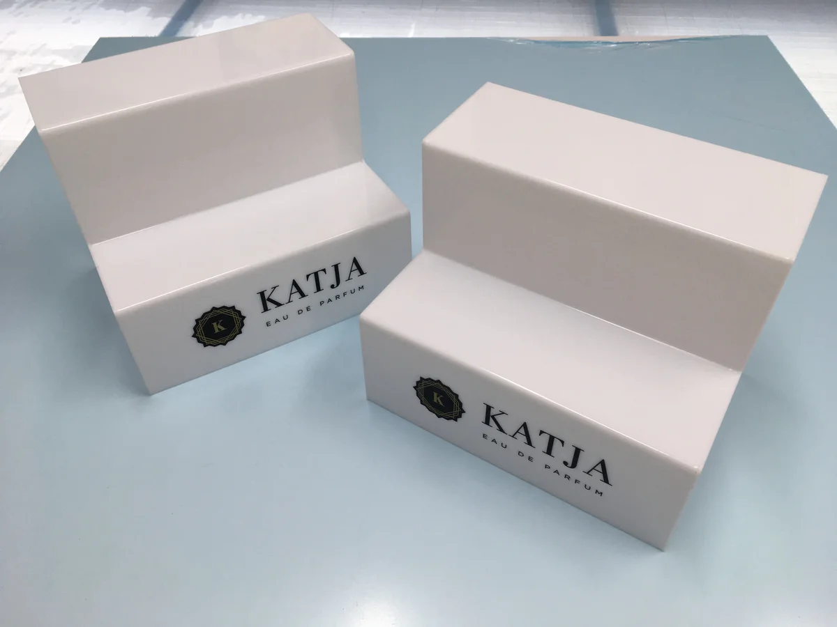 Two displays perfum in white with UV print — stepped with logo Katja