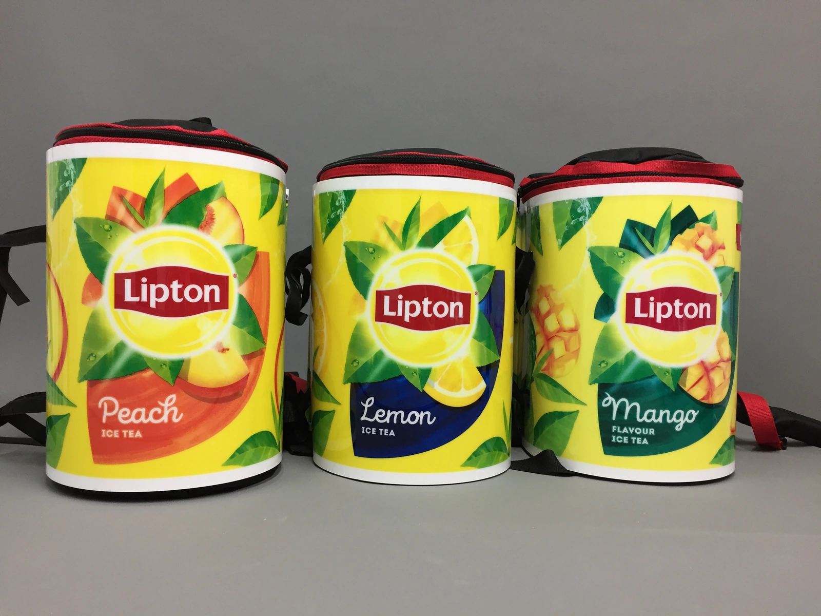 Lipton — Three isothermal containers for beverages with Lipton Ice Tea branding in three flavours (Peach, Lemon, Mango) with adjustable straps