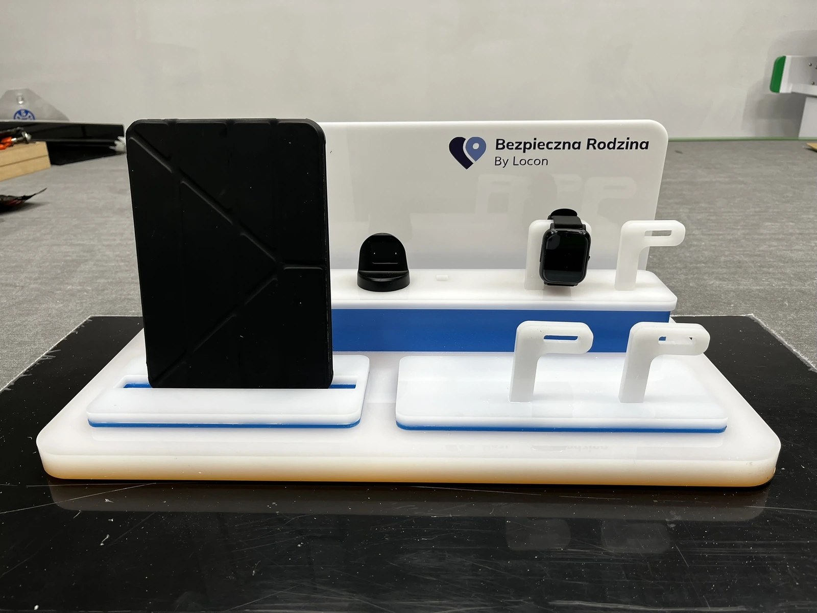 Locon — Standing acrylic display for presenting devices, smartwatches and accessories, white with blue accent