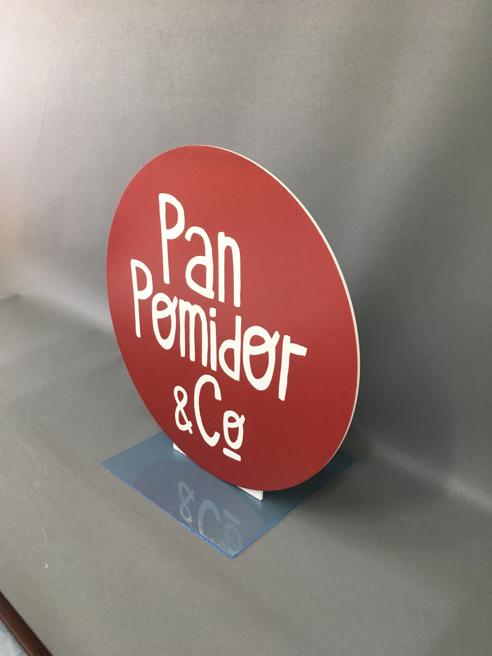Pad Printing & Co — Round lightbox/display from acrylic in colour red from white logo and tekstem, montowany for wall