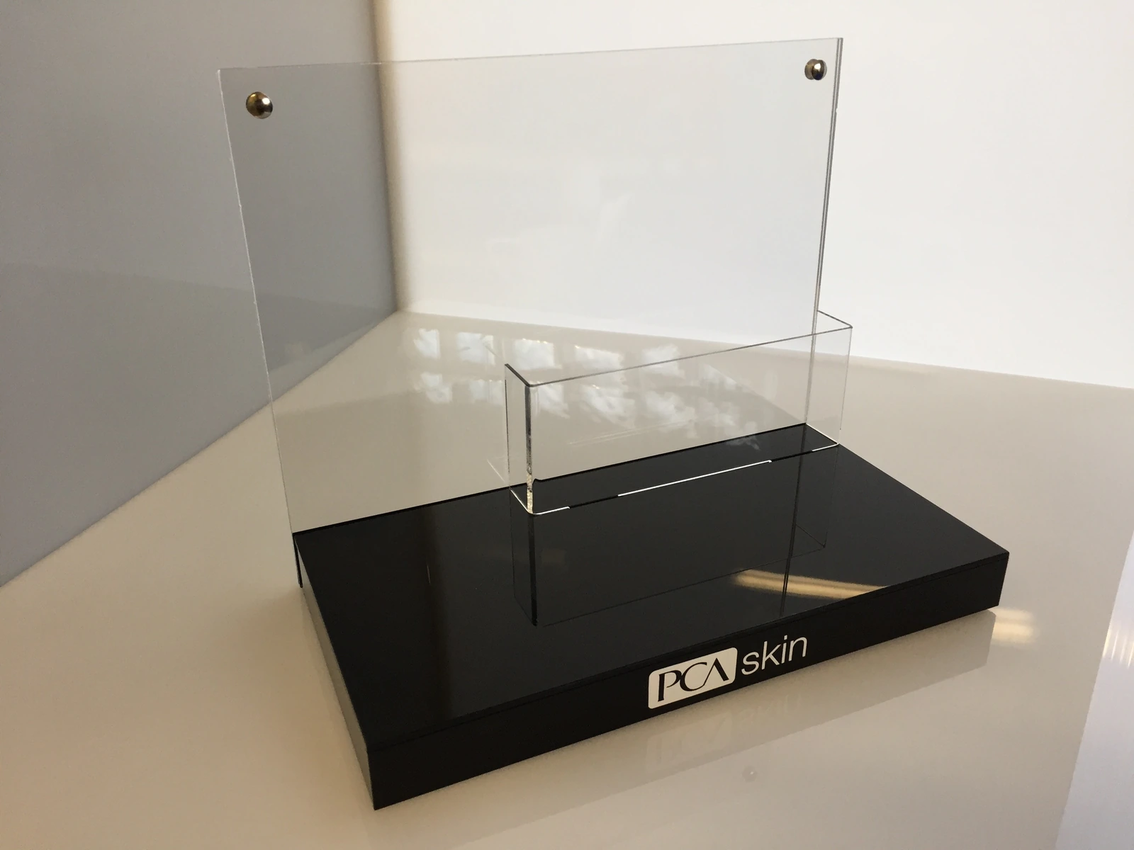 PCA skin — Showcase display from black base and transparent panelami from acrylic for presenting products cosmetic.