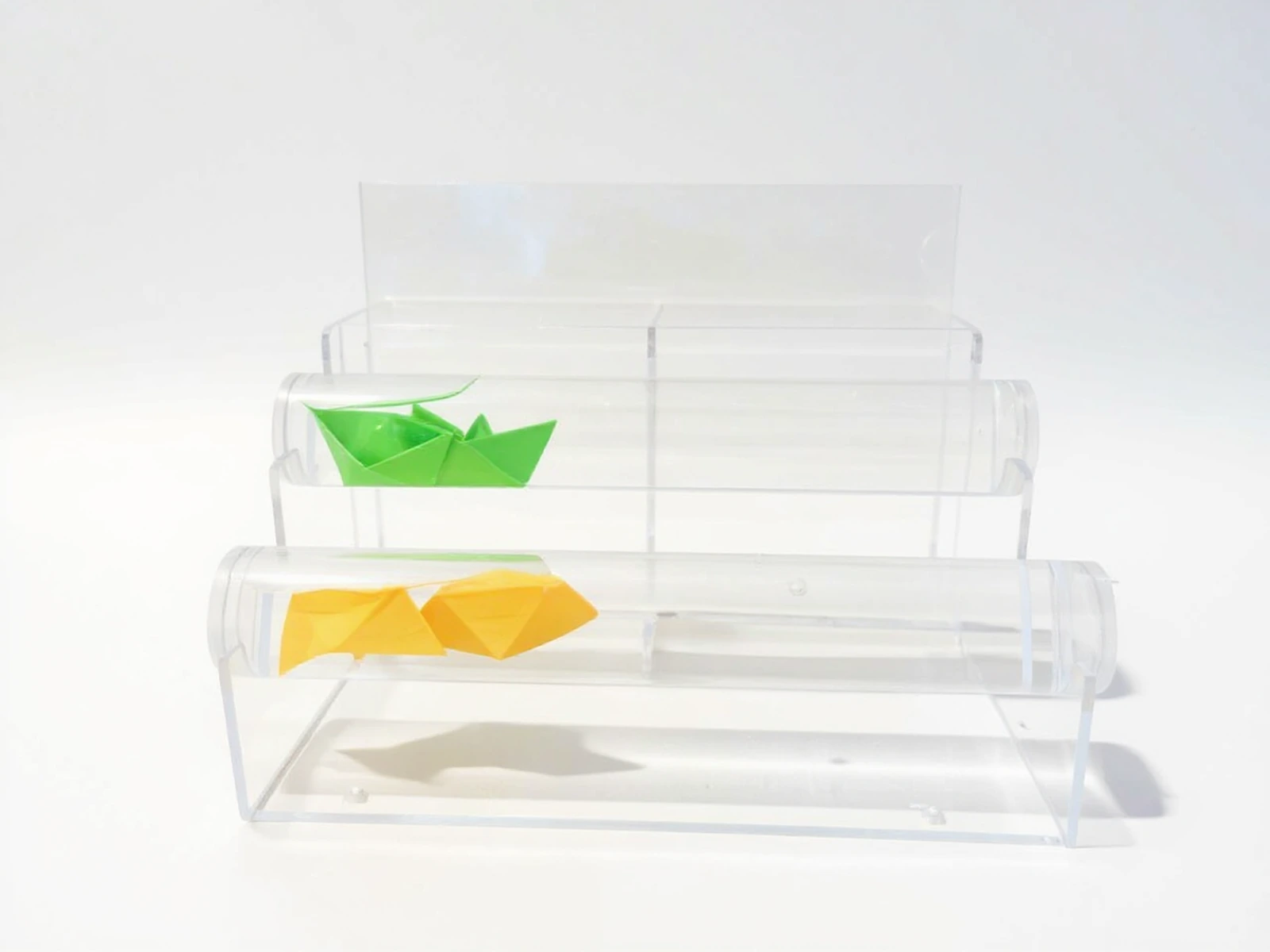 PlexiSystem — Multi-level acrylic display for presenting paper origami boats, made from transparent acrylic with dividers
