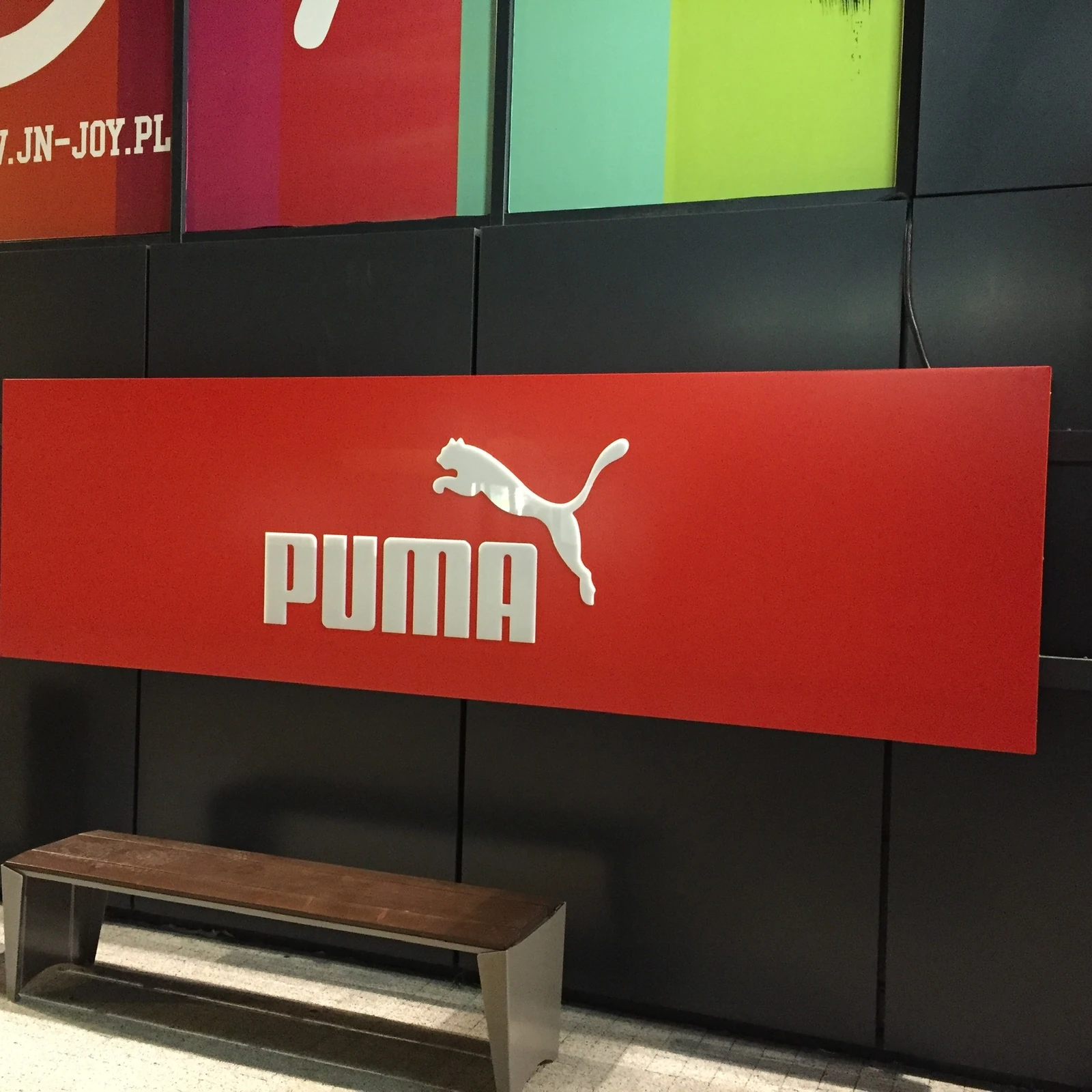 PUMA — Lightbox wall-mounted with logo brand PUMA - red sign advertising from white logotypem and inscription, made from material kompoz