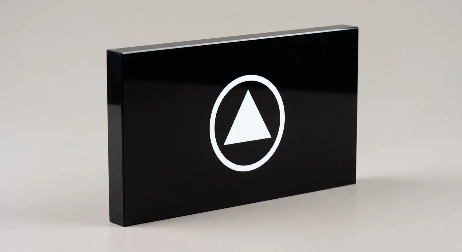 Black gloss acrylic block with a logo printed on the front face