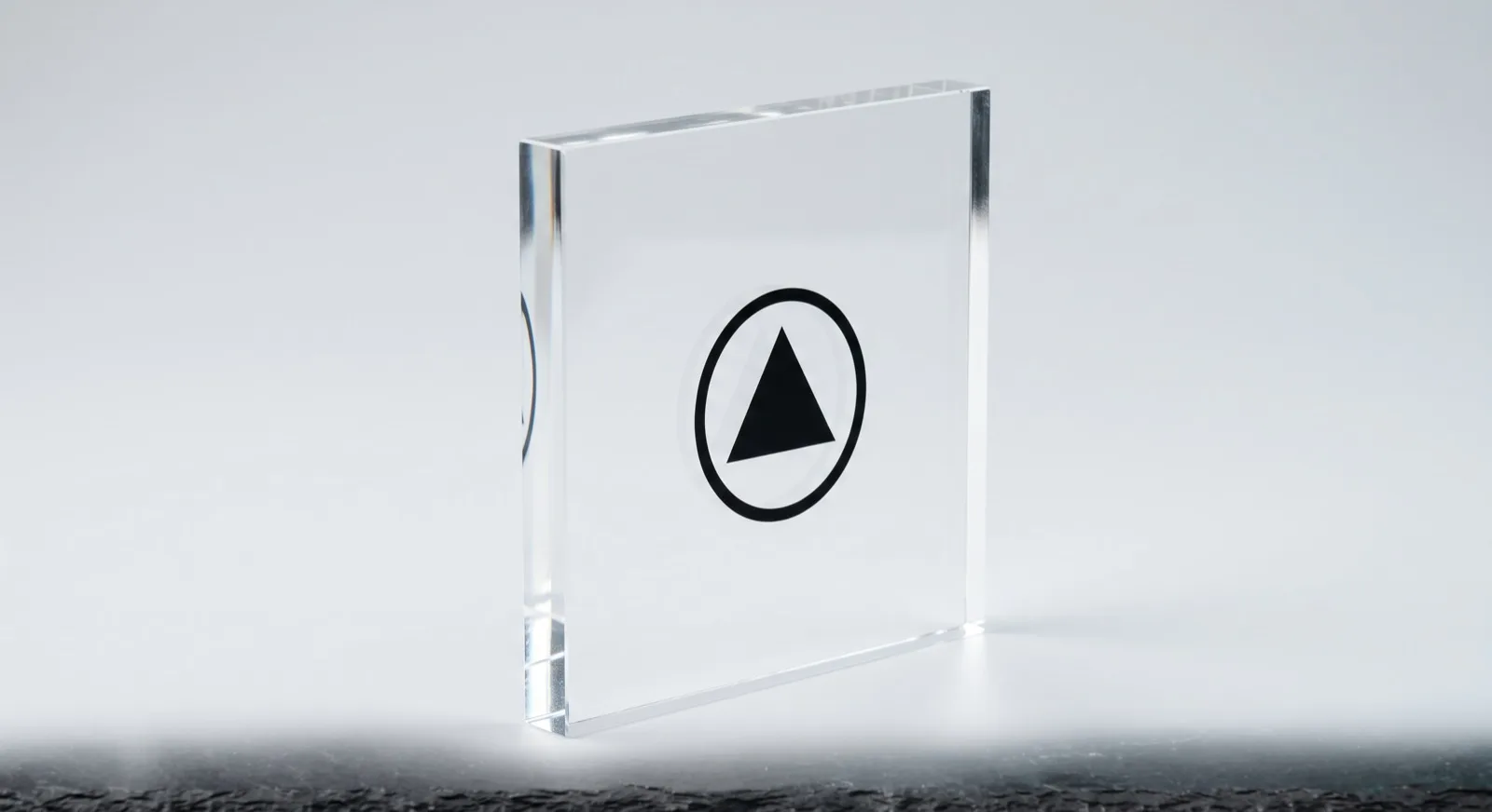 Clear acrylic block with the logo printed on the back face, seen through the material